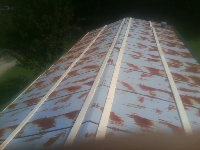 Rusted metal roof panels with new wood purlins before replacement — Storm Damage Roof Repair in Hellertown by Roofing Brothers