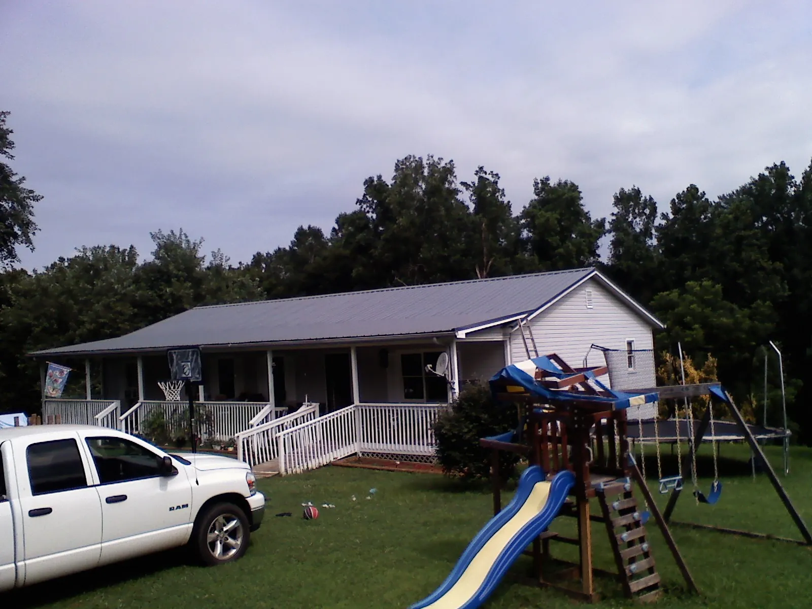Dark metal roof on a country home with a full length front porch in Hellertown